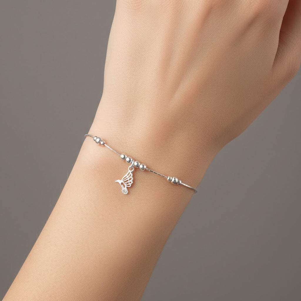 Pulsera con Dije Colibri Calado y Bolitas Lisas con Cadena Cola de Rata Plata .925