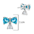 Arete Broquel Pan 1:1 Bridgerton Moño Circonia Azul con Circonia Colgante, Plata .925 con Baño de Rodio